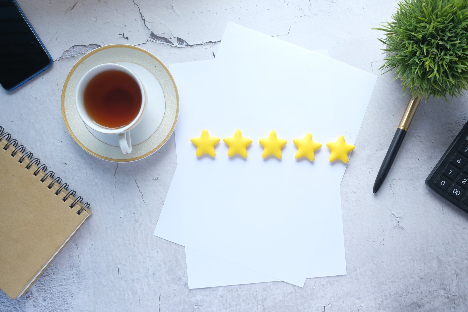 Customer review concept with Rating golden stars on table