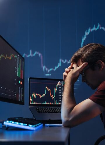 Depressed crypto investor of computer with candlestick chart of crypto currency market