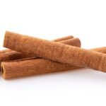 cinnamon sticks stacked on white