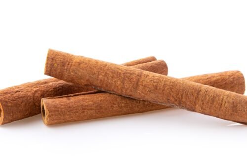 cinnamon sticks stacked on white