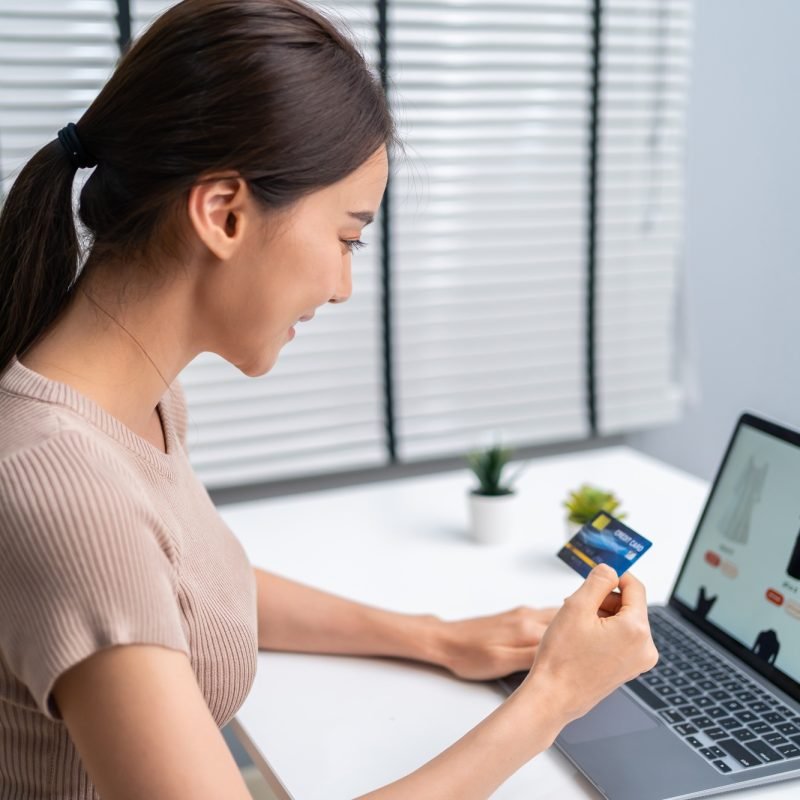 Asian young woman use laptop computer for shopping product sell online.