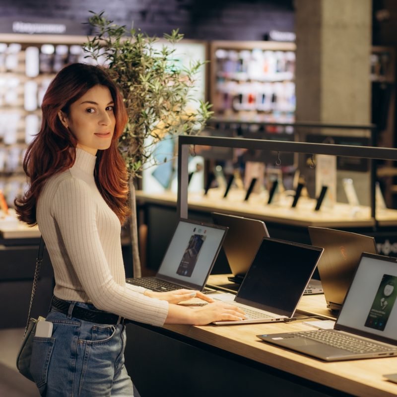 woman buying a laptop in store